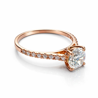 Rose gold ring with a large cz and smaller cz stones on the band against a white background