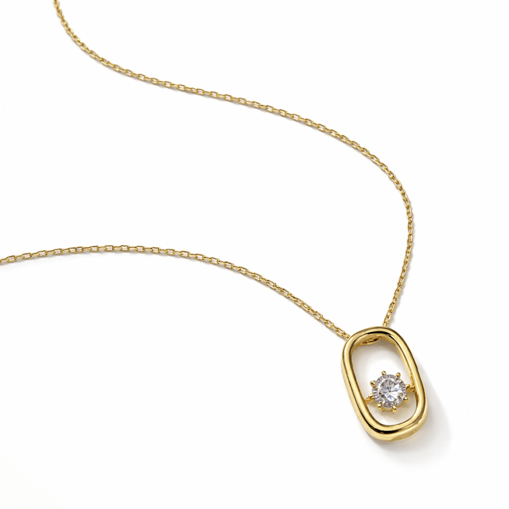 Detail of gold plated sterling silver open oval pendant with centrally set cubic zirconia
