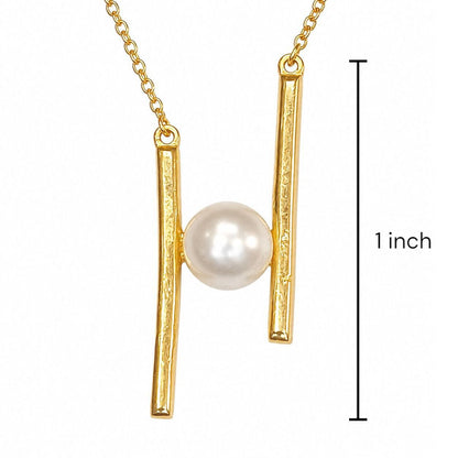 Sterling silver Gold necklace with a pearl pendant suspended between two vertical bar elements, shown on a white background with a black measurement marker reading 1 inch.