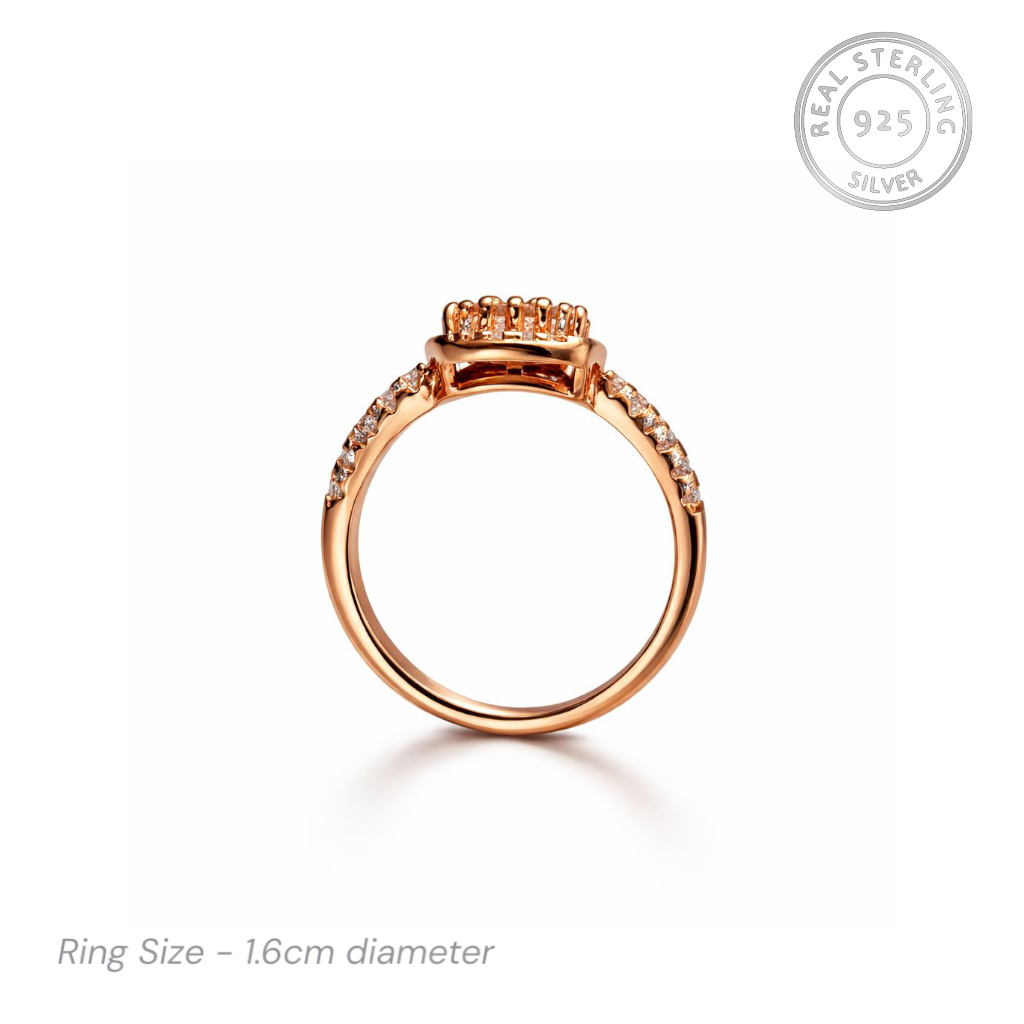 Rose gold ring with gemstones on a white background, featuring 'Real Sterling 925' stamp.
