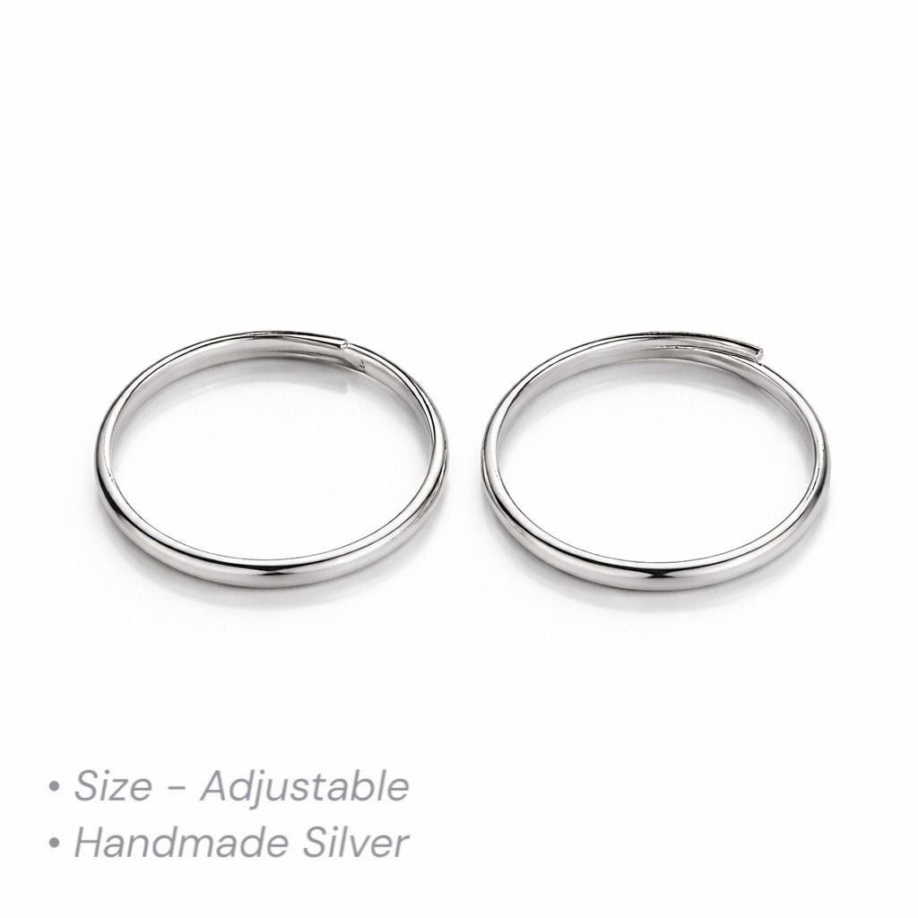 Two adjustable silver thumb toe rings on a white background with text indicating size and material.