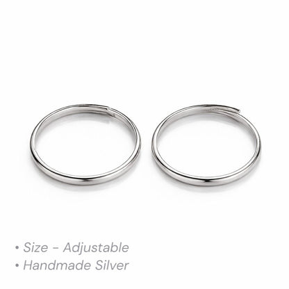Two adjustable silver thumb toe rings on a white background with text indicating size and material.