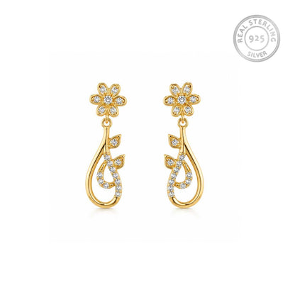 A pair of sterling silver golden dangle earrings with flower-shaped tops set with small clear stones and teardrop-shaped drops with leaf motifs, shown on a white background with a 'REAL STERLING 925' badge in the top right.