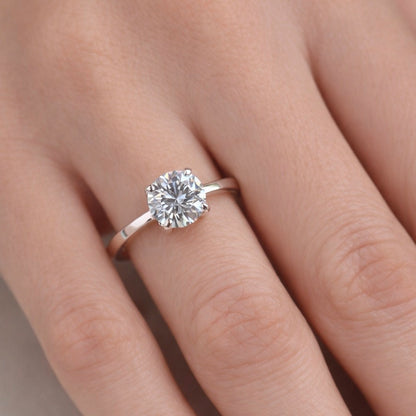 Silver ring with stone on a person's finger